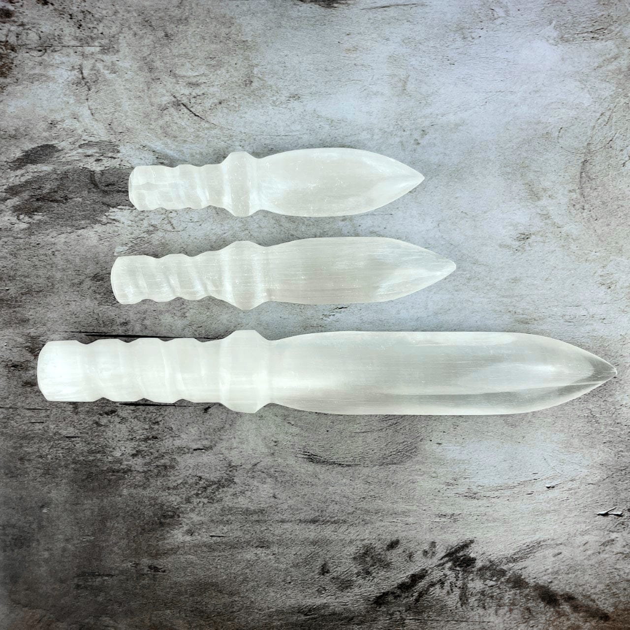 3 sizes of Selenite Knives with Twisted Handles horizontally placed