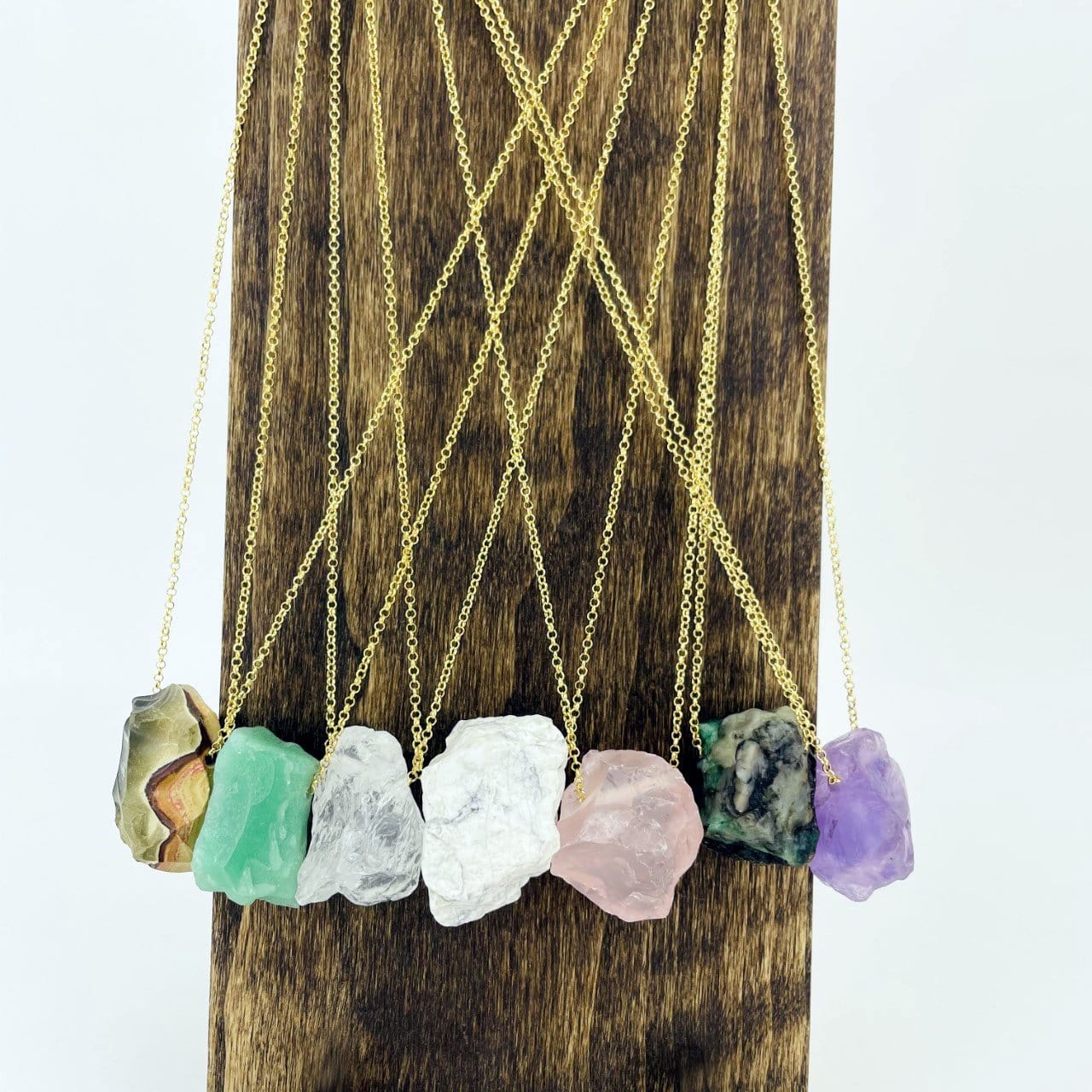 Healing Stone Necklaces with gold chain on stand