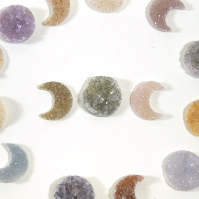Druzy Moon Crescent and Circle Cabochons displayed in a moon phase order crescent circle crescent on white background