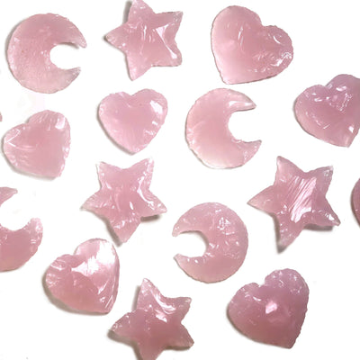 Rose Quartz Colored Glass Hearts Moons and Stars  scattered on a white background