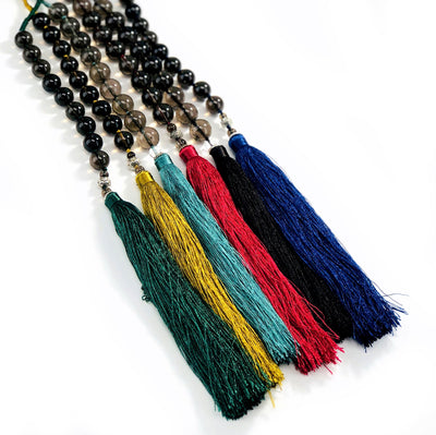 6 Colored Tassels with Smokey Quartz and Assorted Beads on white background