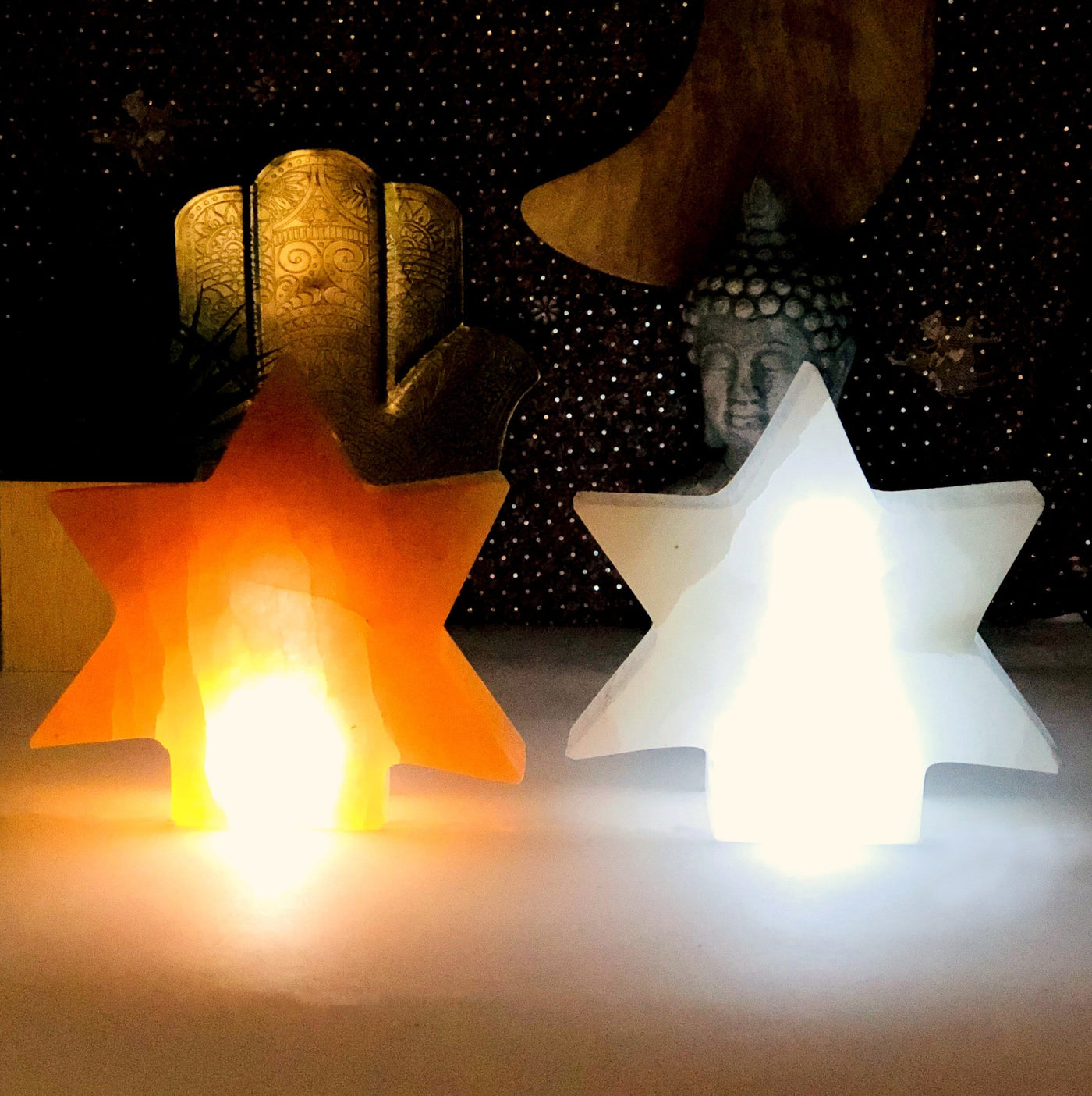 orange and white selenite star lamps turned on in the dark