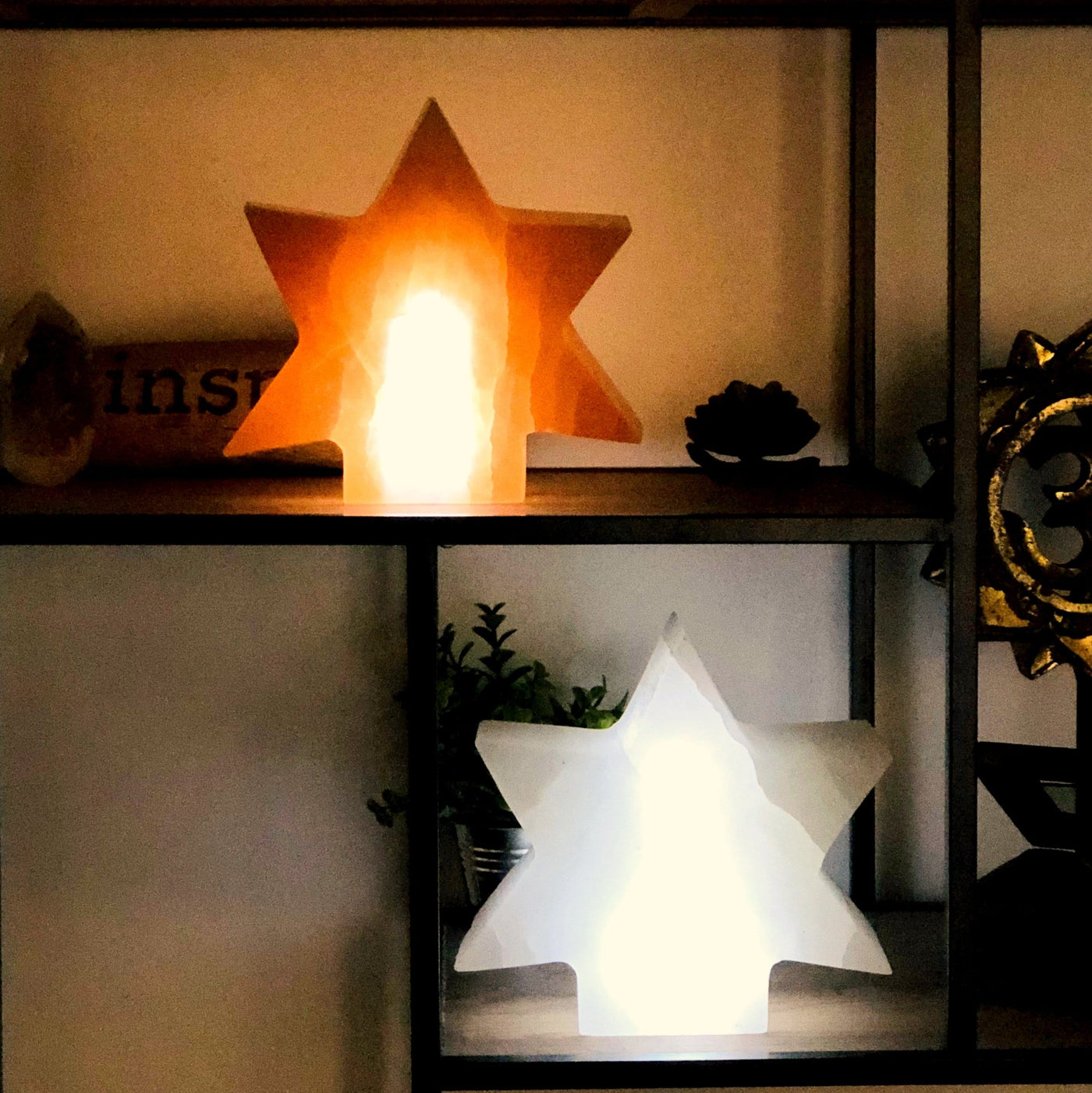 orange and white selenite star lamps turned on in the dark