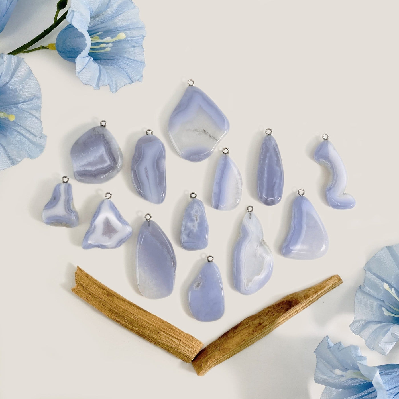 Blue Lace Agate Pendant with a silver tone bail displayed on white background to show color shape and characteristic variations