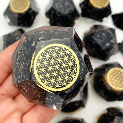 Orgone Energy Black Tourmaline with Gold Flower of Life Grid Dodecahedron shaped displayed in hand for size reference