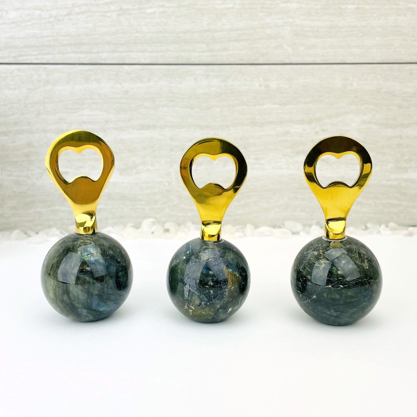 Bottle opener that has a labradorite sphere as the bottom part and a gold opener part.  Photo shows assorted openers to show slight variation in stone.