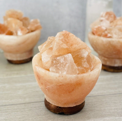 3 Himalayan Salt Lamps on gray background