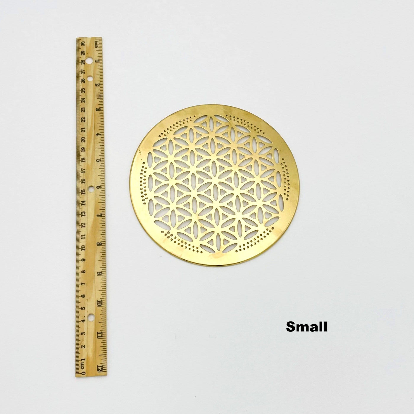 flower of life grid available in small size. displayed next to a ruler for size reference