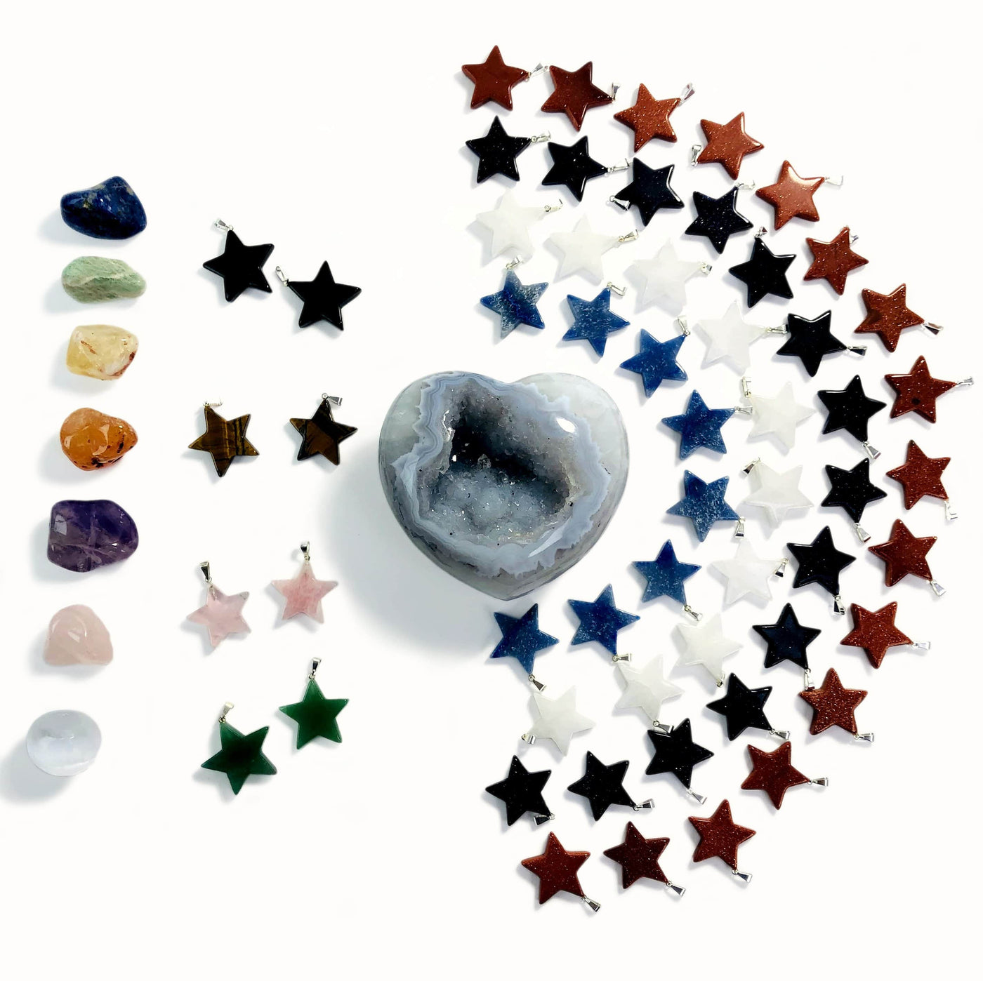 multiple gemstone stars with silver bails displayed to show the differences in the crystals 