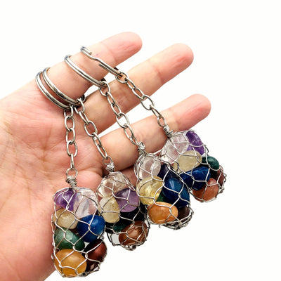 four seven stone chakra tumbled stone silver keychains in hand for size reference