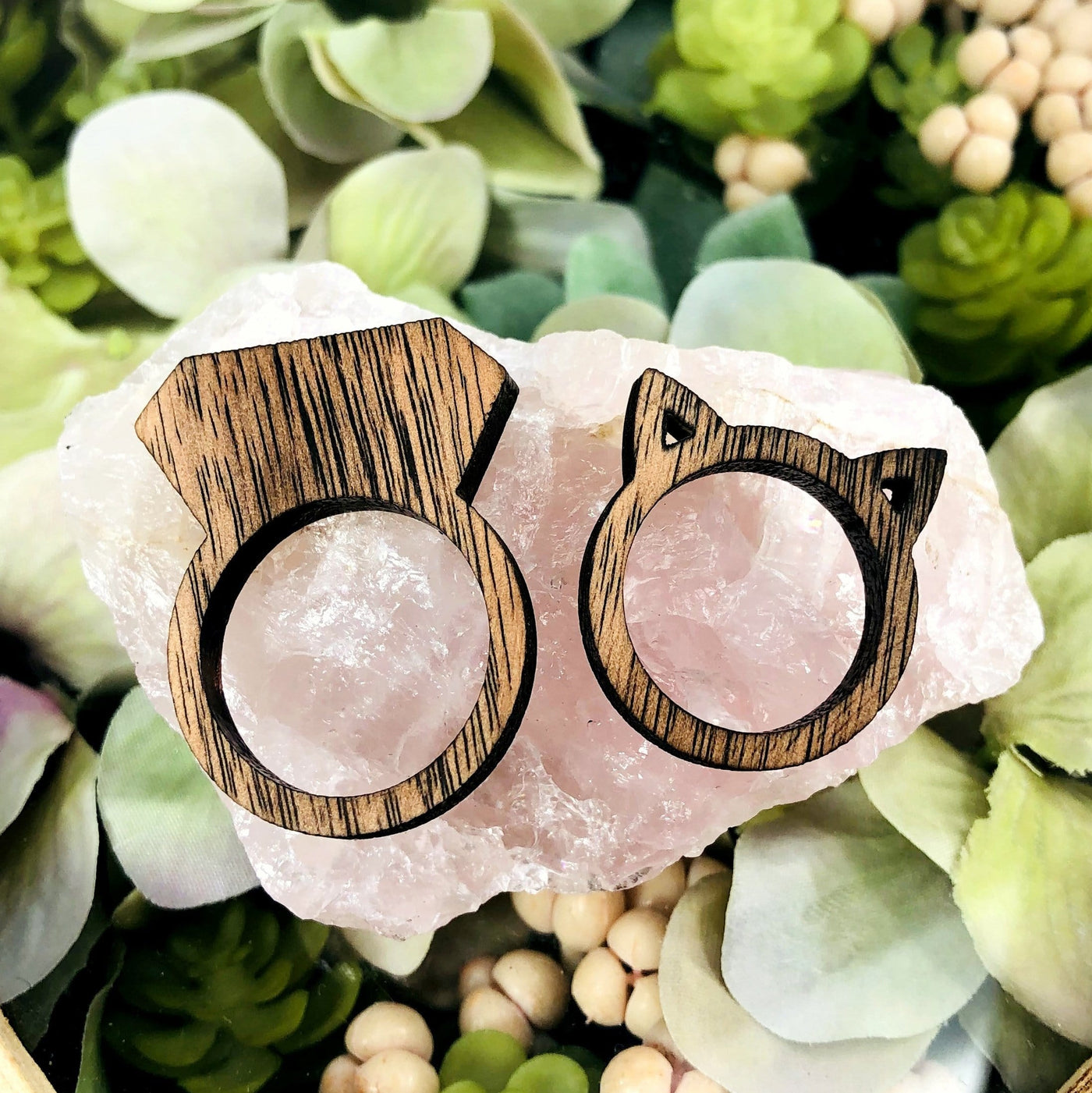 Wooden Cat and Ring Shaped Rings on a stone