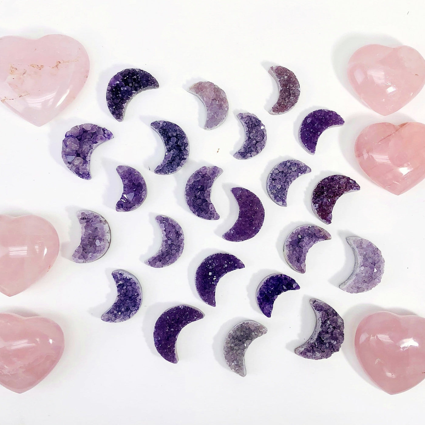 multiple Amethyst Druzy Moon Crescent UNDRILLED Cabochons displayed to show various colors textures sizes and characteristics on white background
