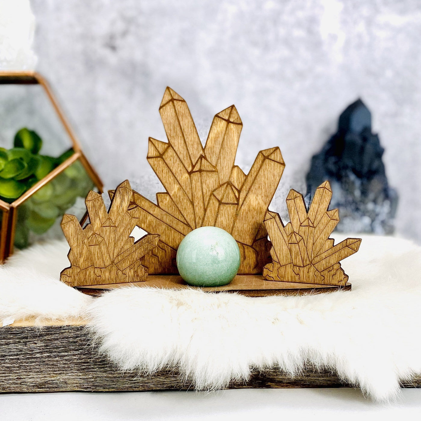 Crystal Point Wooden Sphere Stand-- sphere on wooden stand for size purposes on log.