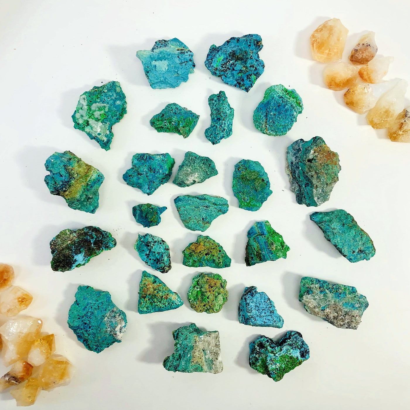 Many Azurite Mineral Stones spread out on a table showing colors, sizes and shapes