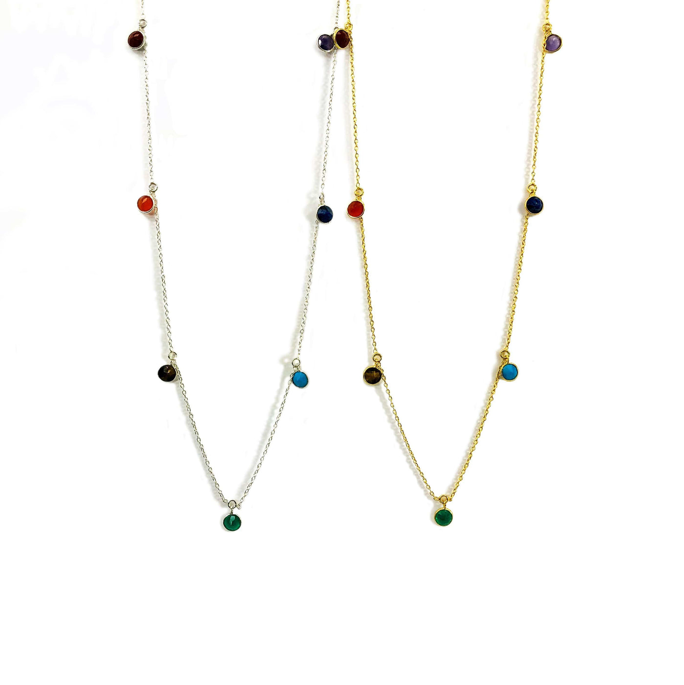 silver and gold seven chakra dangle necklace on white background 