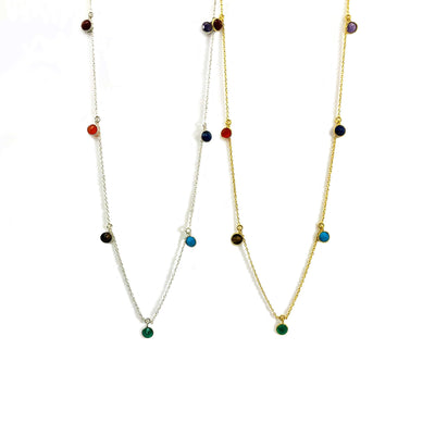 silver and gold seven chakra dangle necklace on white background 