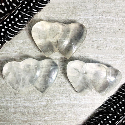 3 crystal double hearts on a table