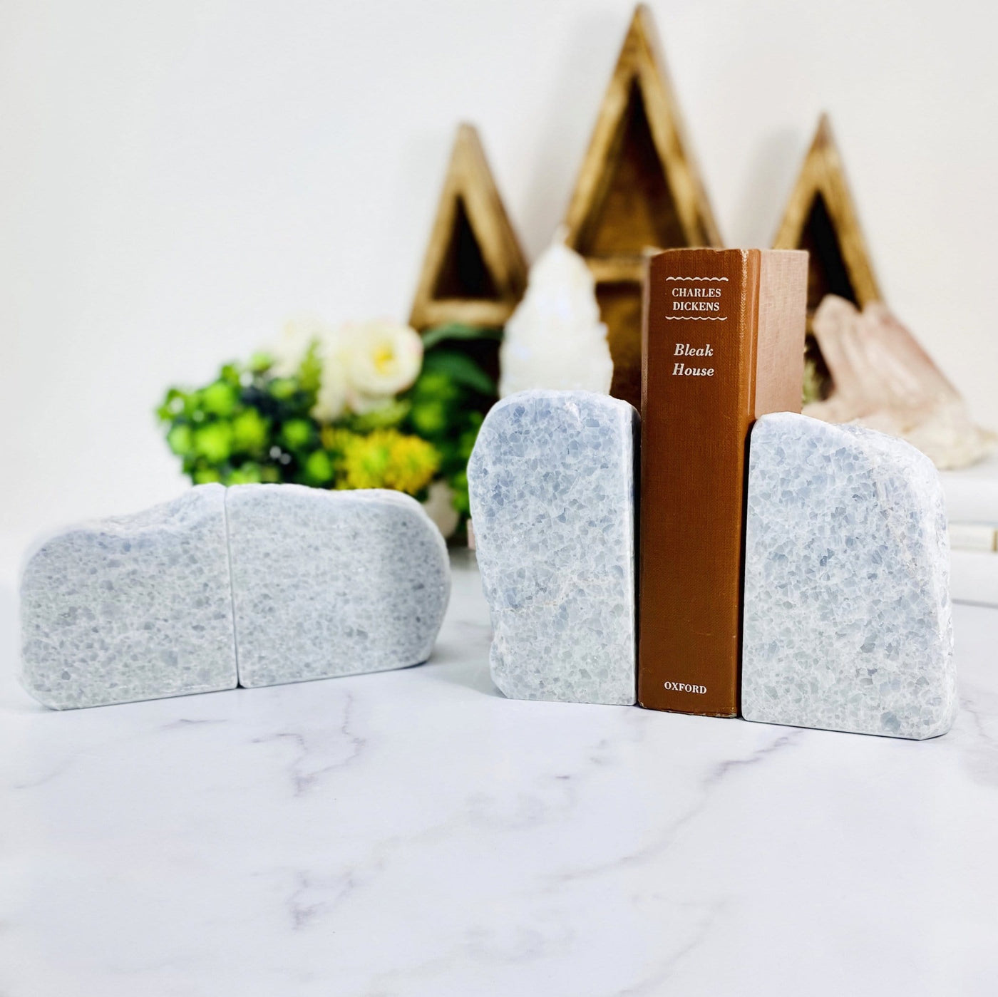 2 calcite book ends with a book and decorations blurred in the background