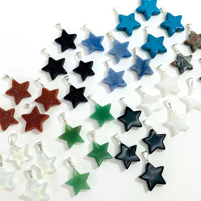 multiple star shaped pendants displayed to show the differences in the gemstones available 