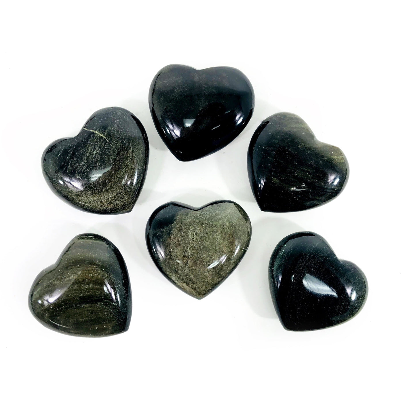 Multiple Polished Gold Sheen Obsidian Hearts displayed to show various sheen and black in stone