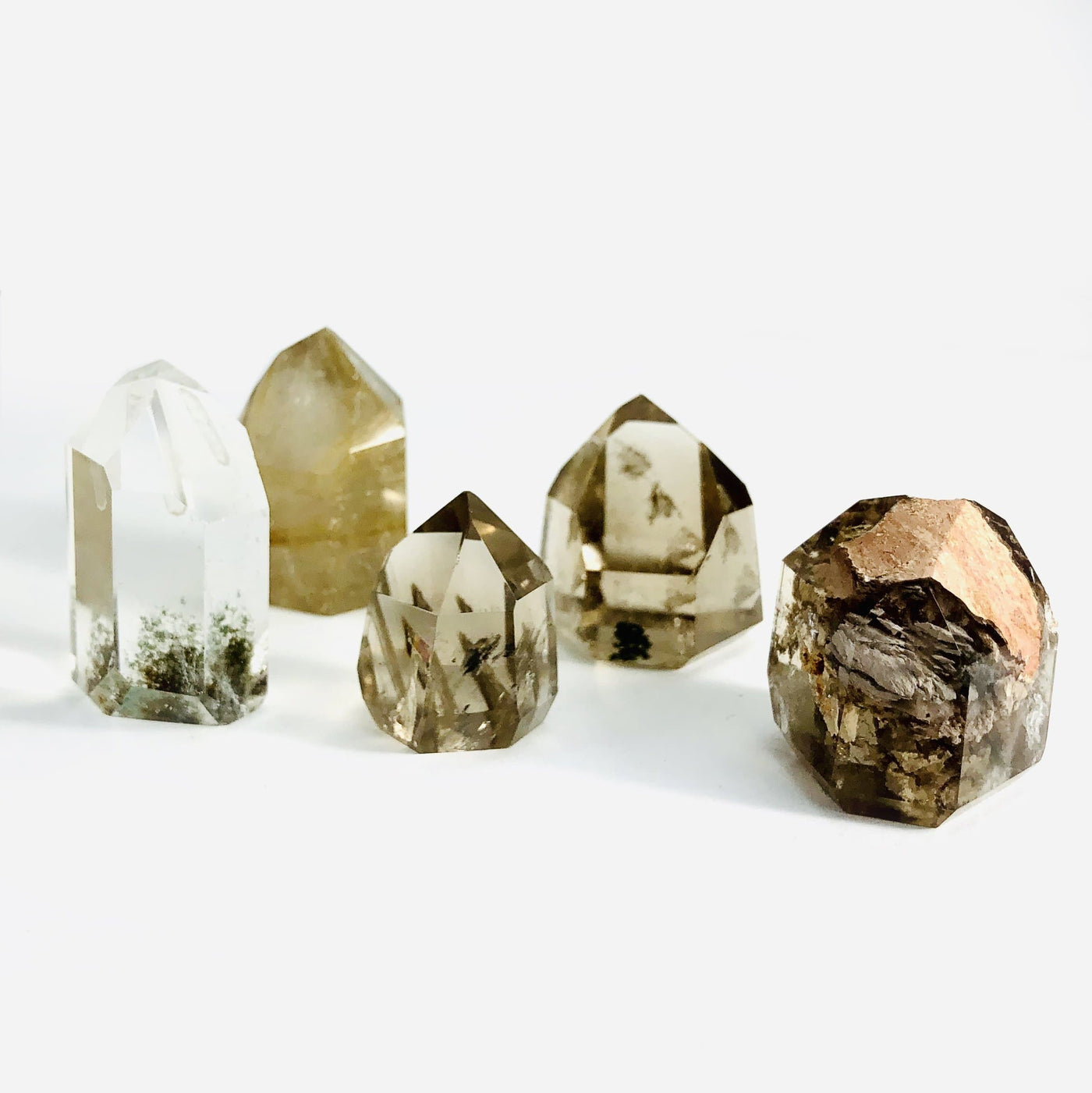 5 crystal points with inclusions on white background