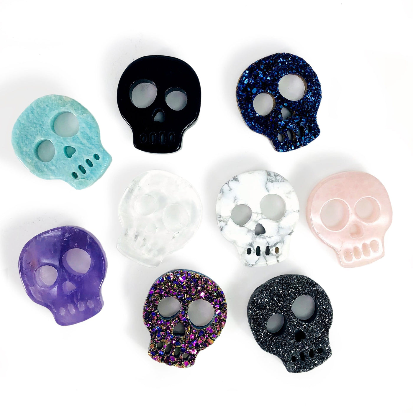 Gemstone Skull Cabochons  - 9 on a table