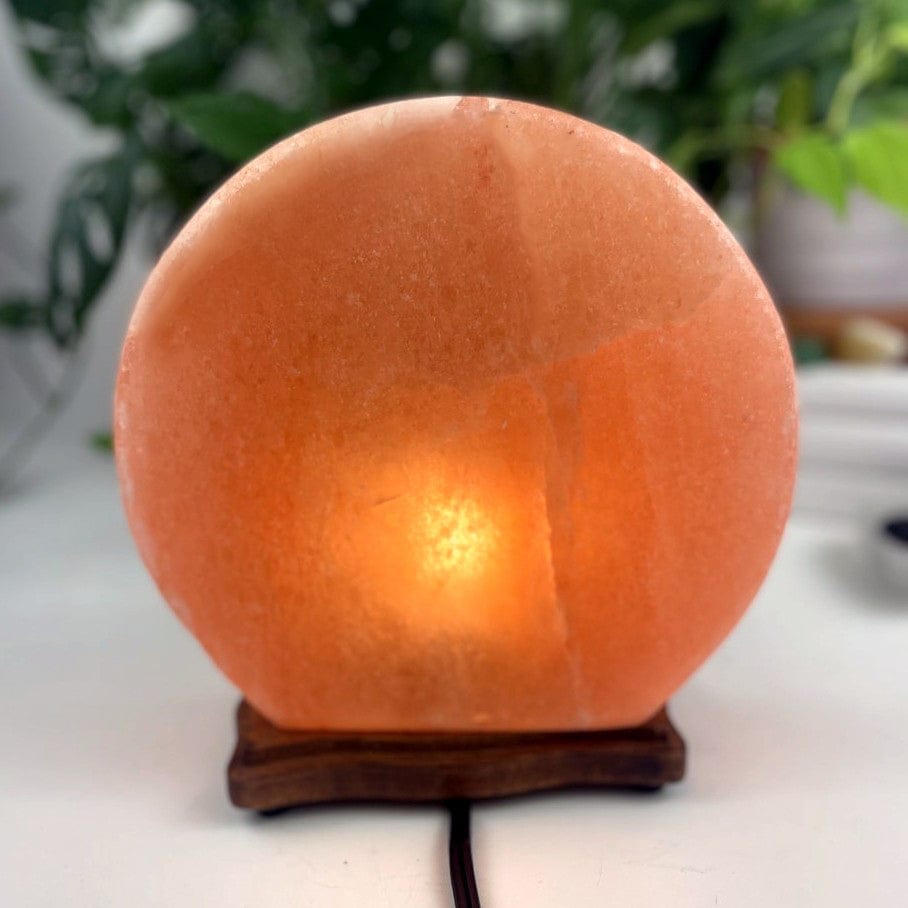 Himalayan salt lamp with sun moon design upside down sold as is from back