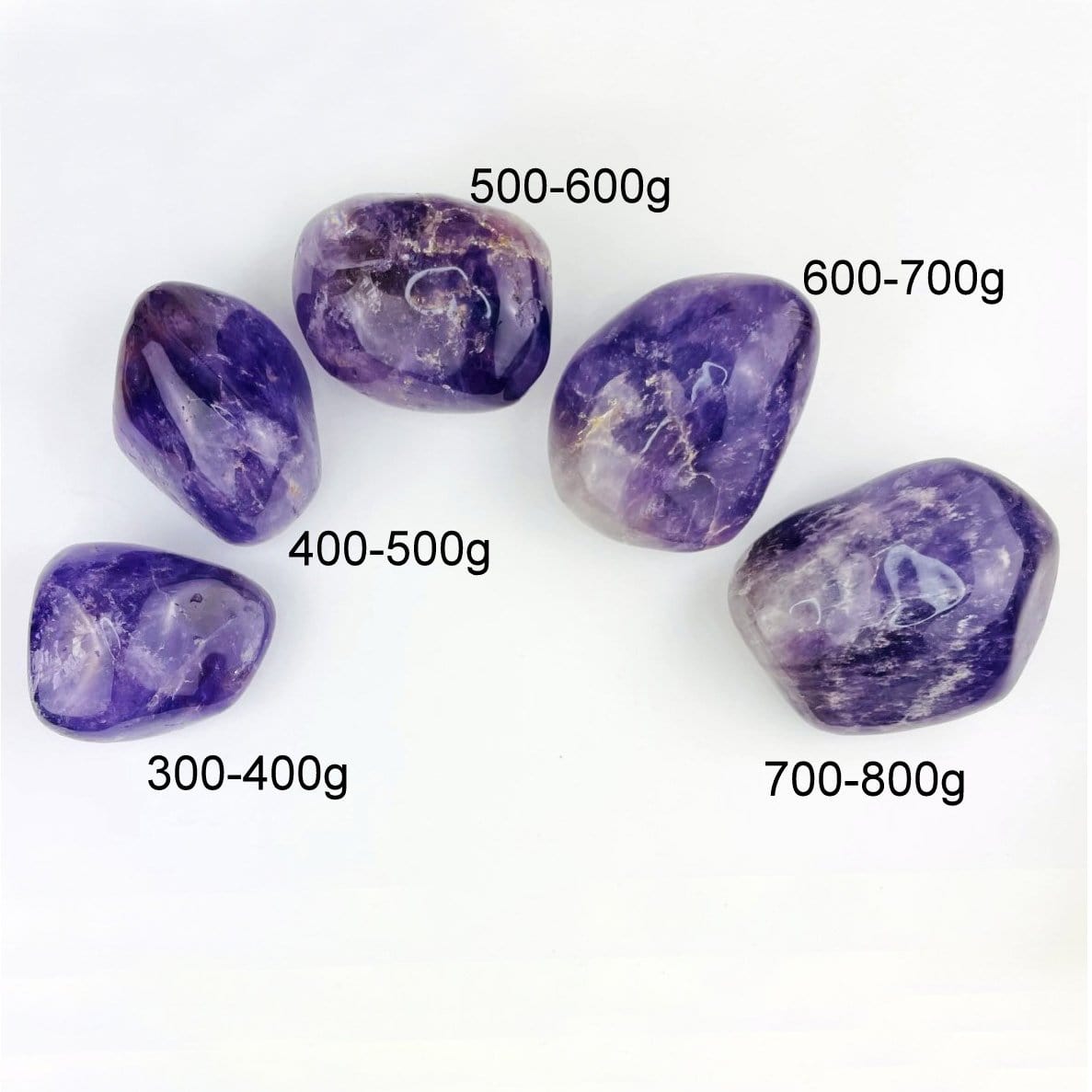 5 different sized amethyst tumbled stones on white background