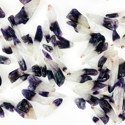 Polished Amethyst Points spread out on a table