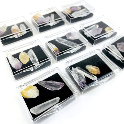 9 boxes of Natural Mineral Points - Amethyst Crystal Quartz and Citrine showing varying size and shapes of stones, shown here at an angle showing depth of box