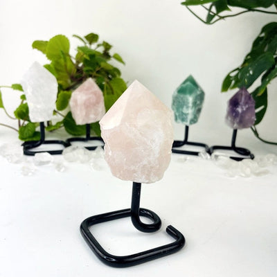 Semi Polished Points on Metal Stands up close of the rose quartz