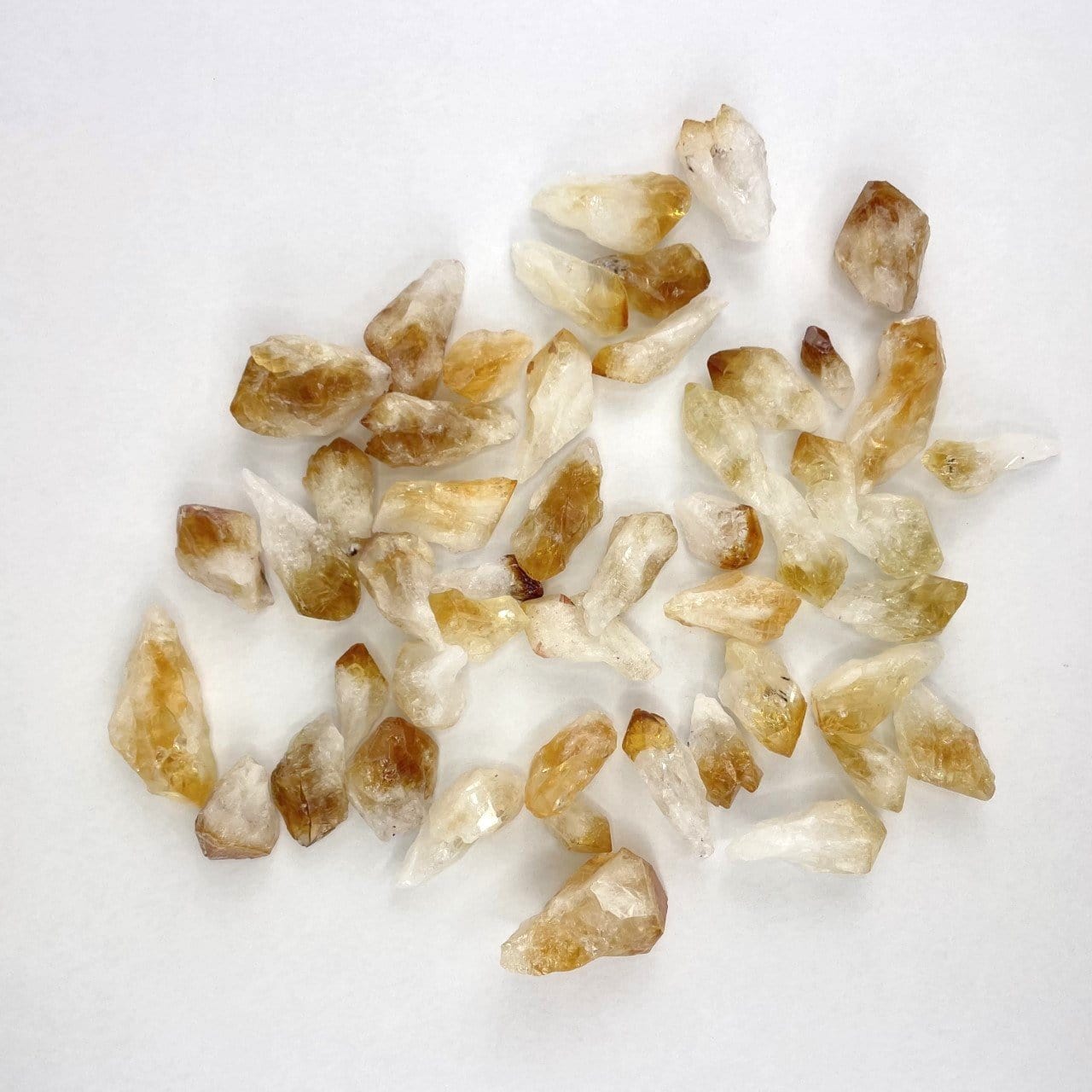 raw citrine points spread out on a table