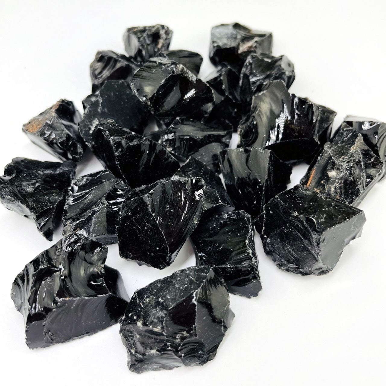 Black Obsidian Natural Stones in a pile from the side view