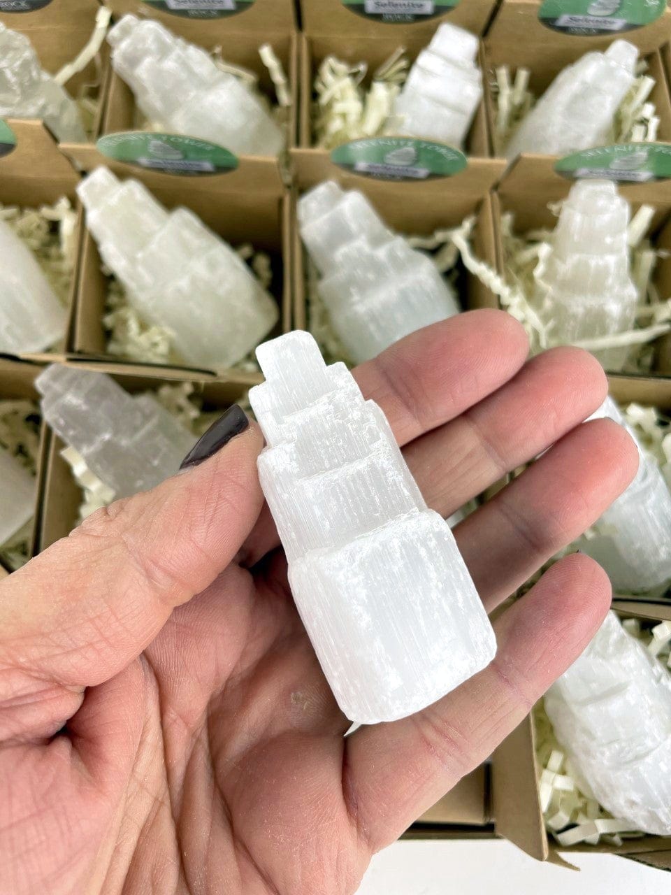 Point of Purchase Box of 32 smaller boxes with Selenite towers in each, one in hand