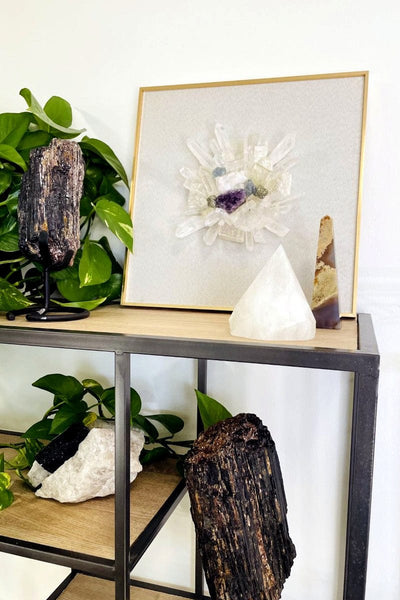 cluster of crystal art on shelf with other decorations