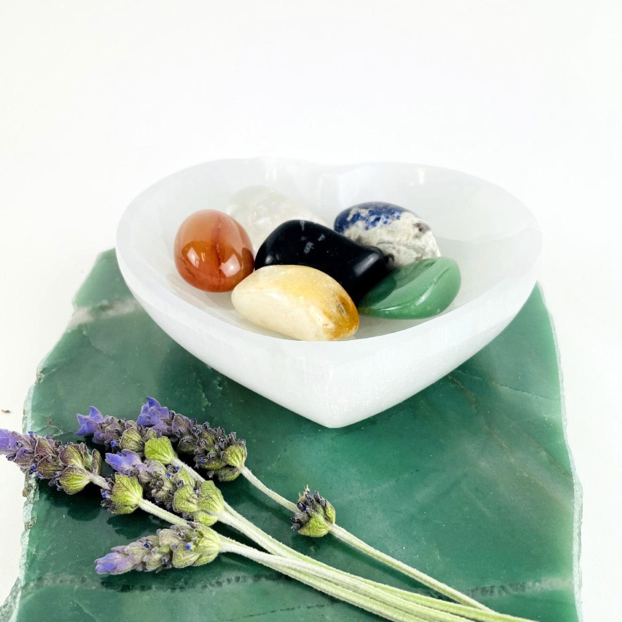 angled view of selenite heart bowl with stones