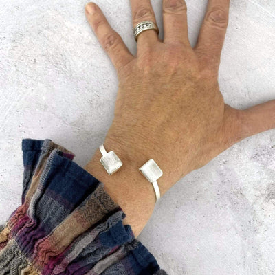 silver selenite cuff bracelet on wrist for size reference