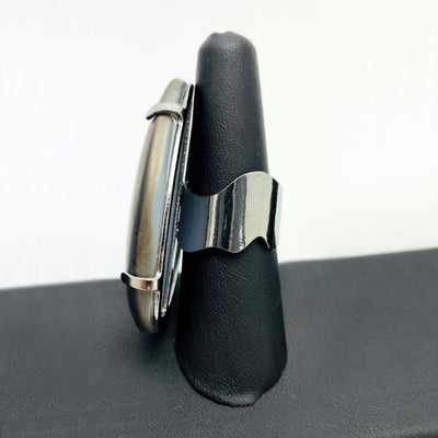 Side view of one black druzy ring on a black ring holder.