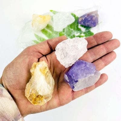 Rough Stone - Triple Energy Stone Set - Amethyst, Quartz, and Citrine in a hand for size