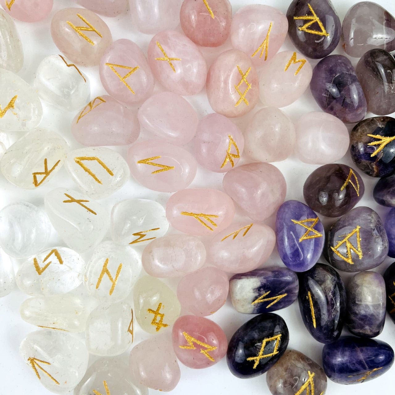 rune stones with gold alphabet on tumbled stones of crystal quartz, rose quartz, and amethyst