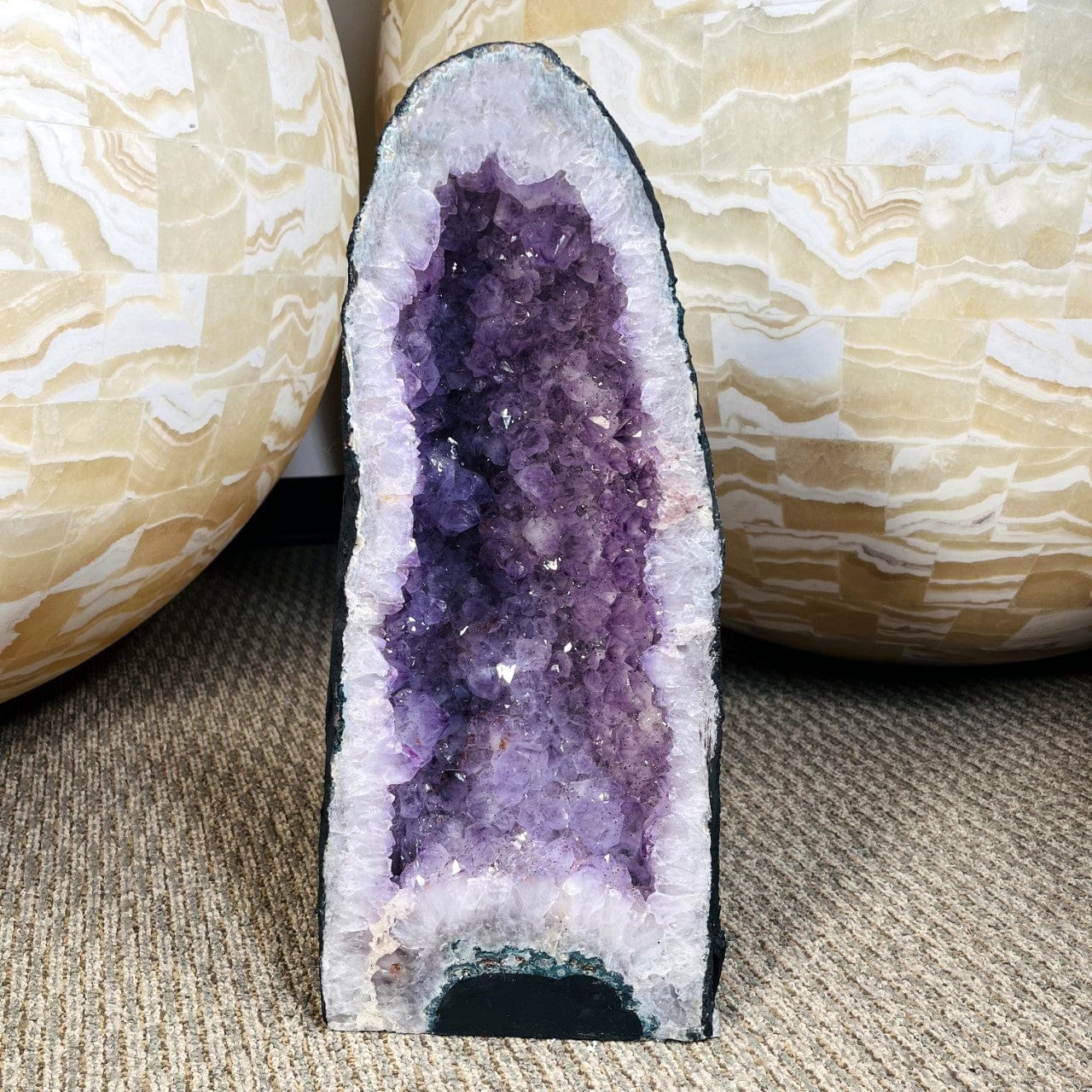 Amethyst Crystal Cathedral Geode with large gloses in the background