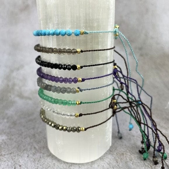 Gemstone Bracelet - Adjustable Cord with Gold Plated over Sterling Silver Beads one of each stone available, pyrite, moonstone, green onyx, labradorite, amethyst, black spinel, smoky quartz, and chinese turquoise all from the side view showing side beads