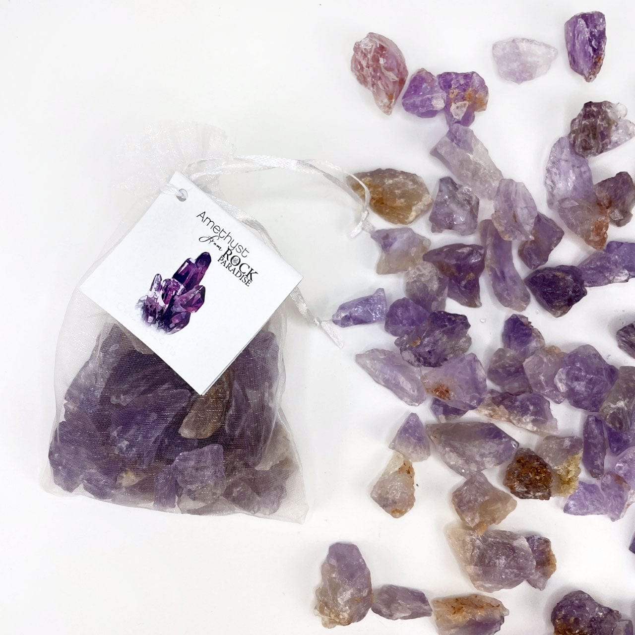 Amethyst Stones - Tied & Tagged in an Organza Bag next to some stones