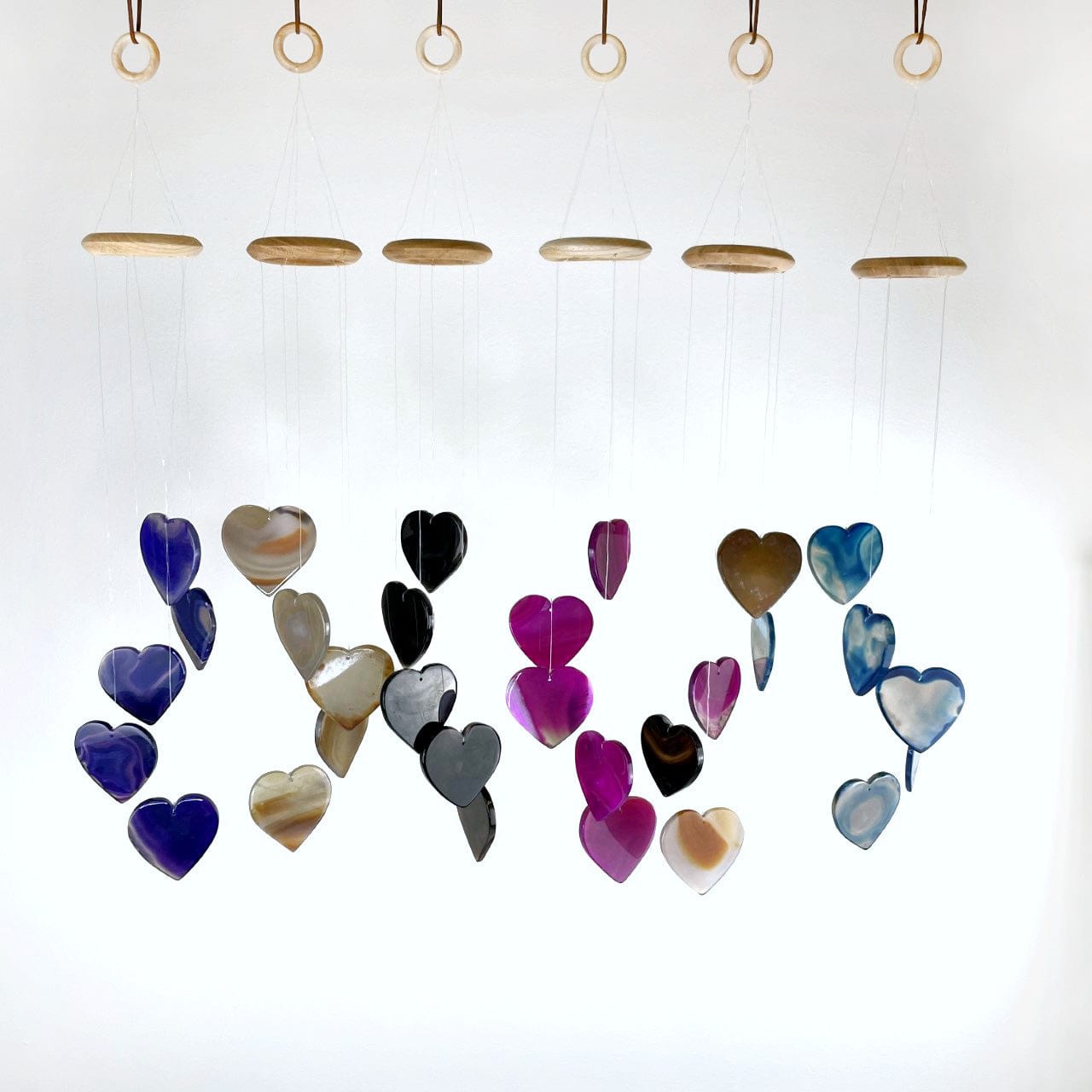 All colors of  Agate Heart Wind Chimes hanging in a row