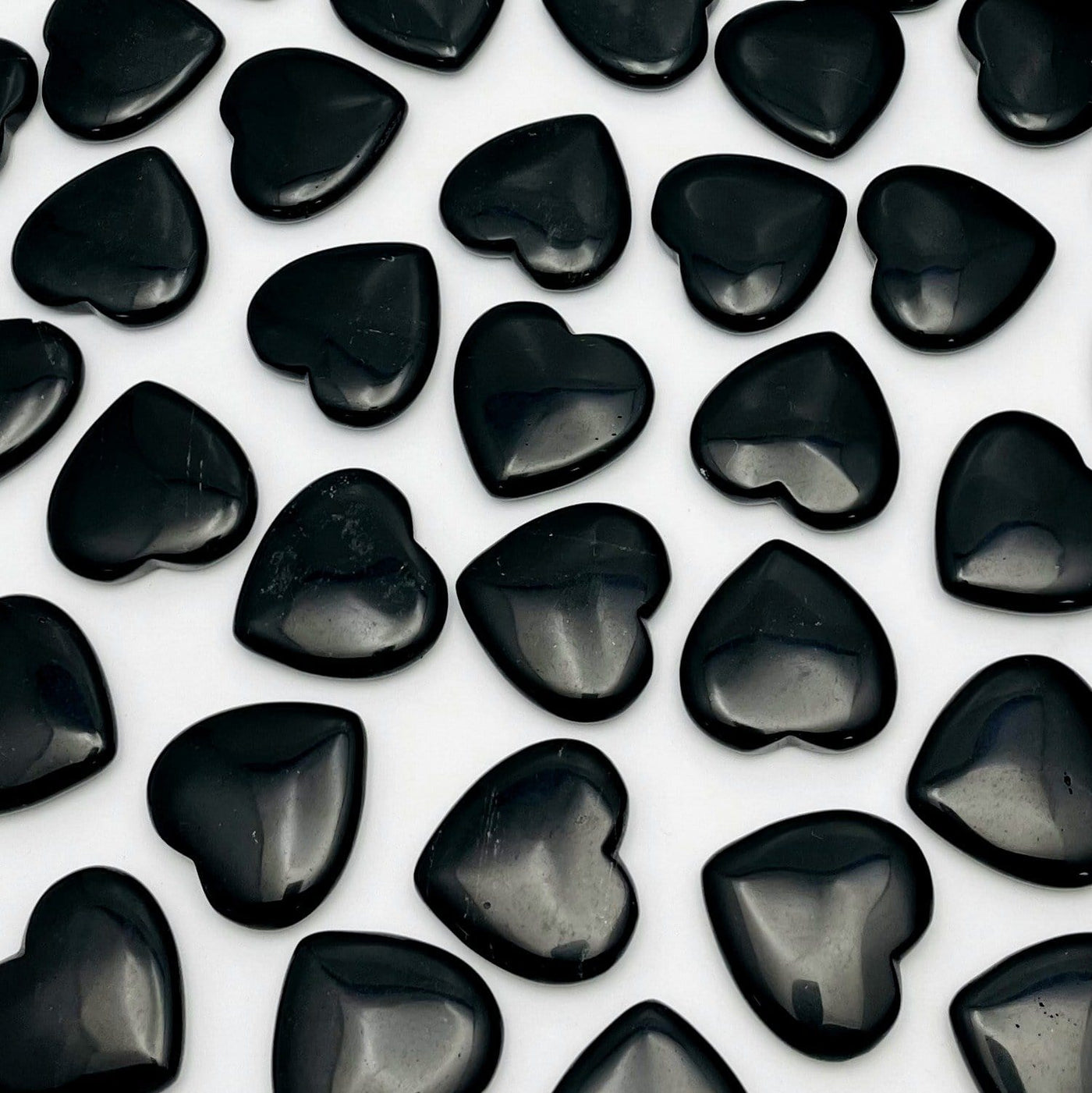 Black Obsidian Hearts scattered on white background