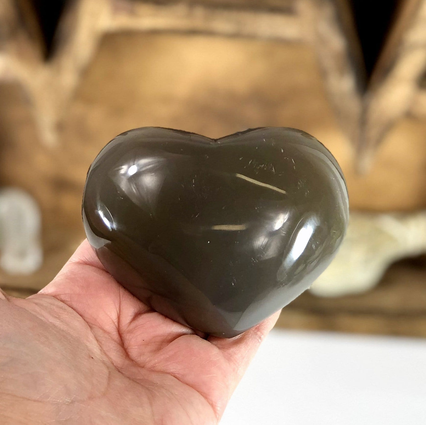 Back side view of Agate Druzy Heart (DOOAK-S24-29) in a hand.