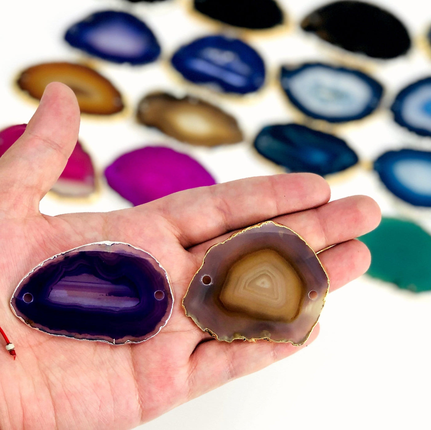 Picture of our purple and natural agate  slice being displayed in hand for size reference.