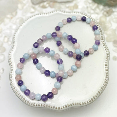 Multi-Stone Round Bead Bracelet with beads of Rose Quartz Amethyst Blue Calcite displayed to show various shades for the beads in each gemstone