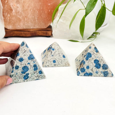 3 k2 pyramids on white background white with black and blue speckled design