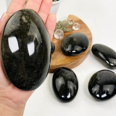 obsidian palm stone in a hand